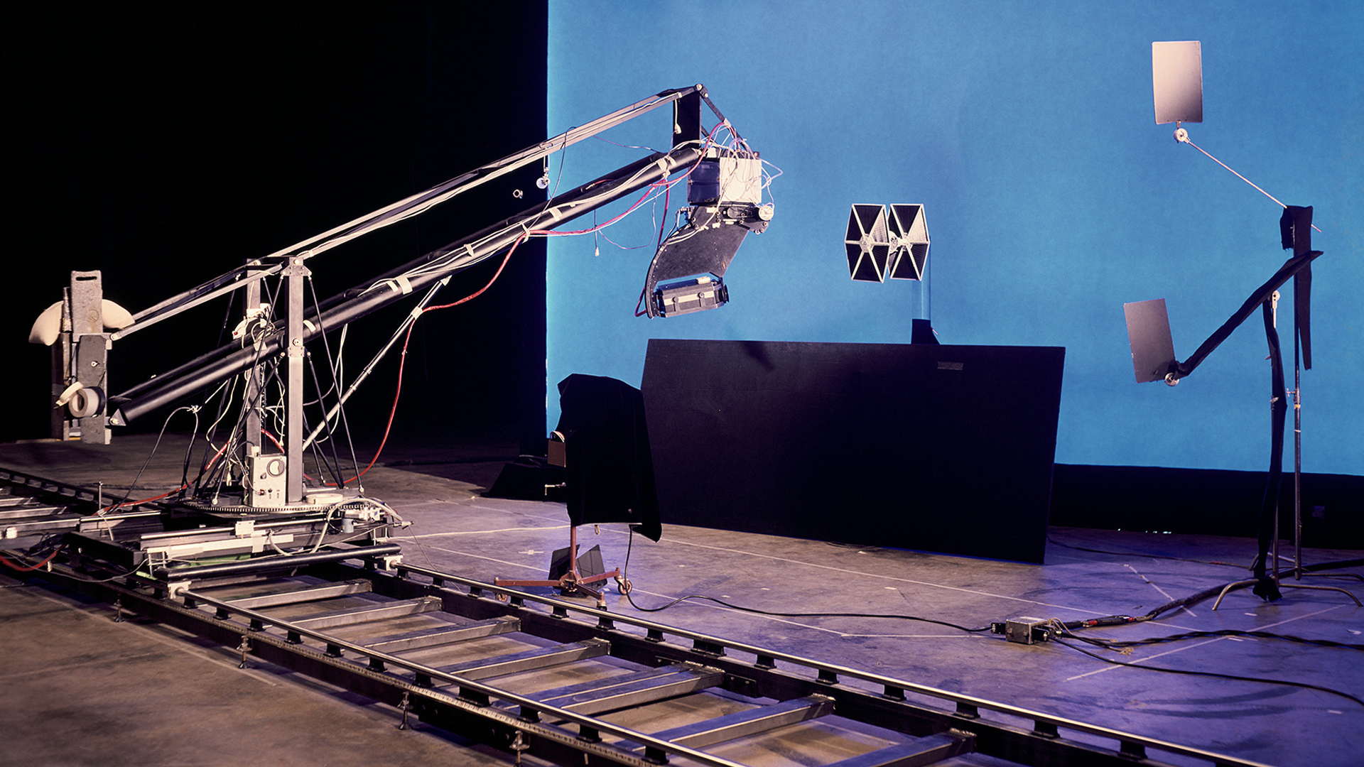 The Dykstraflex camera system sits ready to film a bluescreen pass of a T.I.E. Fighter model on ILM’s Van Nuys studio stage. © Industrial Light & Magic. All Rights Reserved