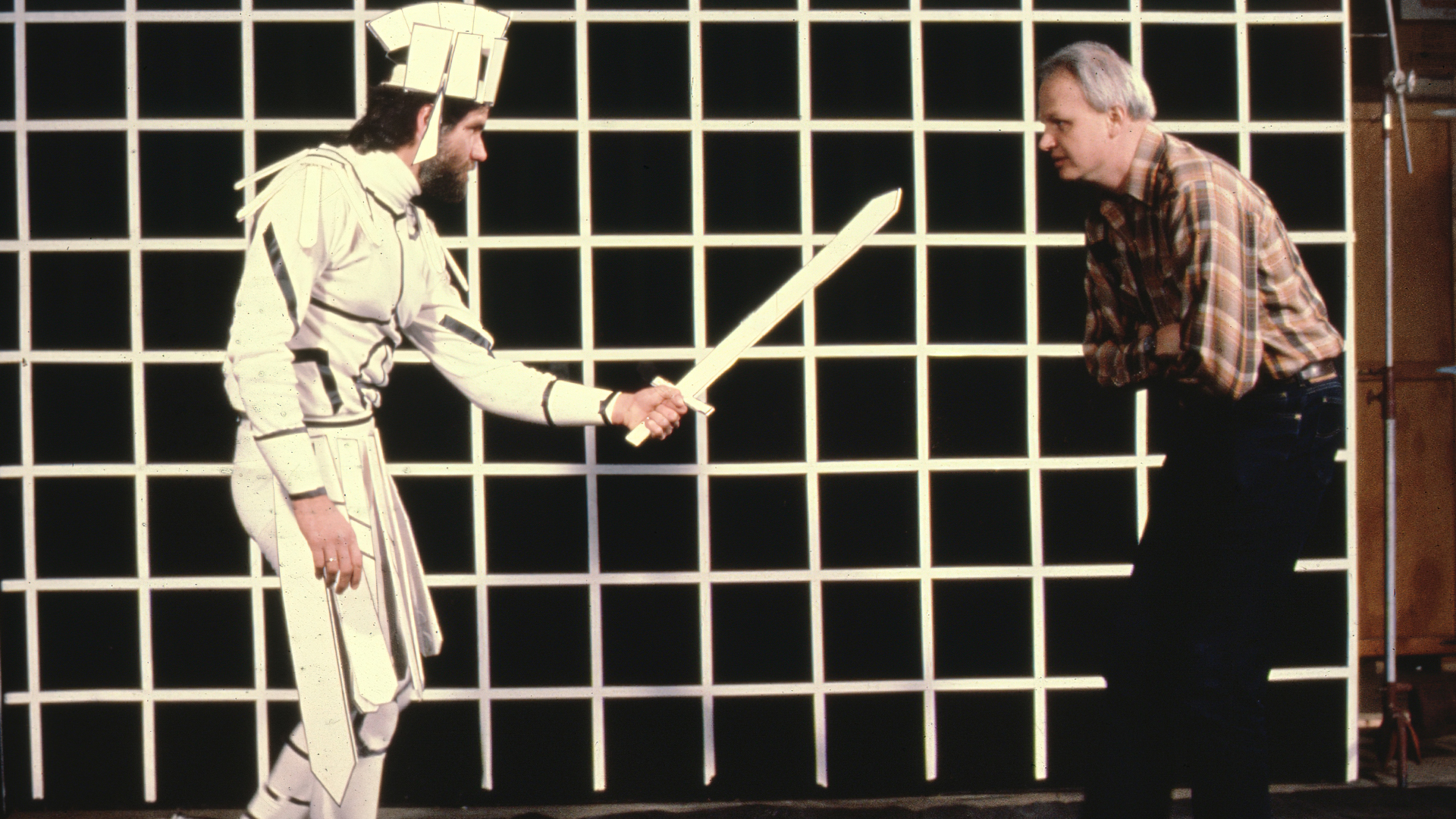 Visual Effects Supervisor Dennis Muren works with a performer against a grid while filming reference footage for animators to use when creating the performance of the stained glass man character in Young Sherlock Holmes (1985). © Industrial Light & Magic. All Rights Reserved.