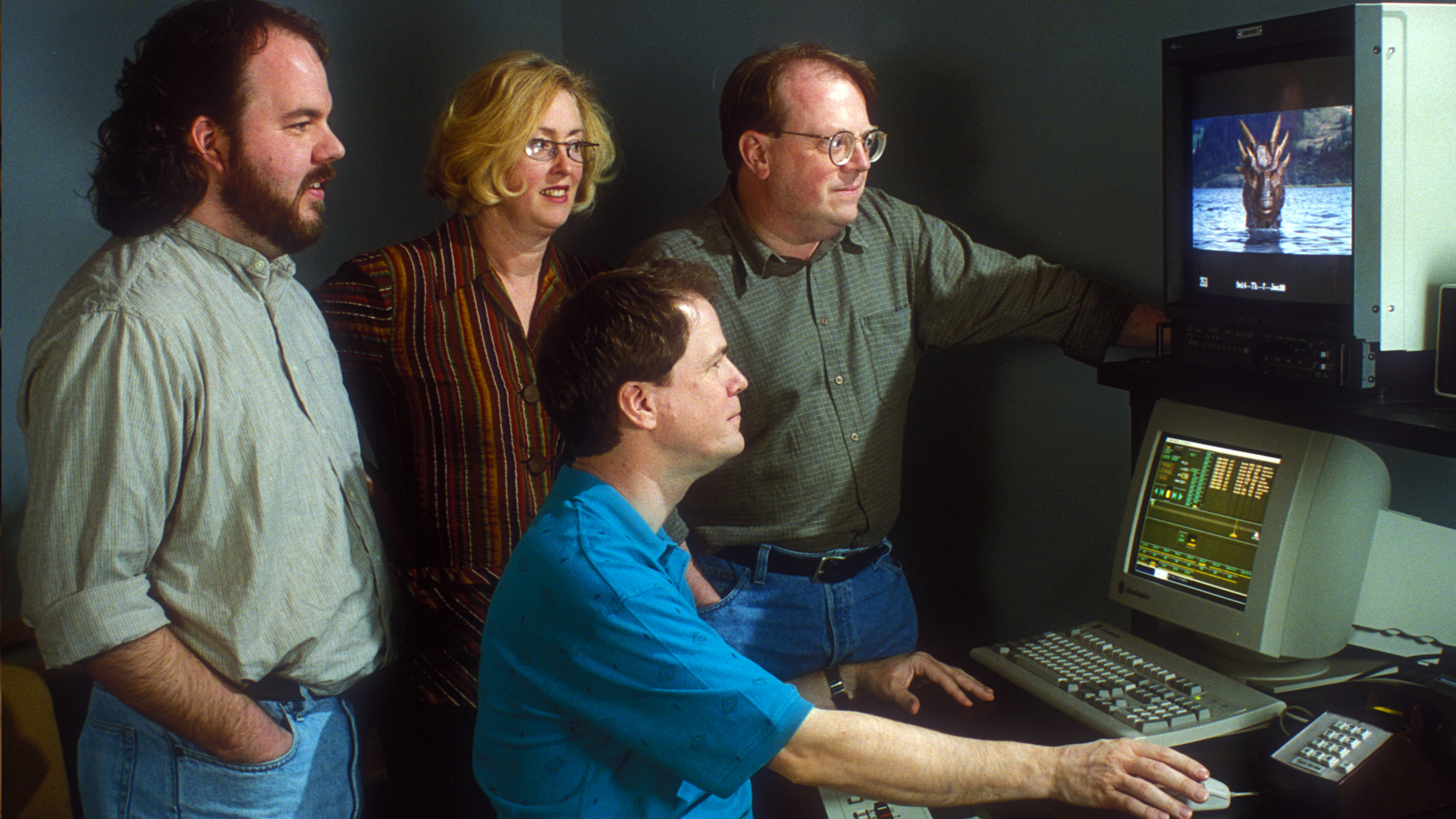 Scott Squires, Rob Coleman and members of the Dragonheart (1996) visual effects crew review a shot of Drago breaching the water’s surface.