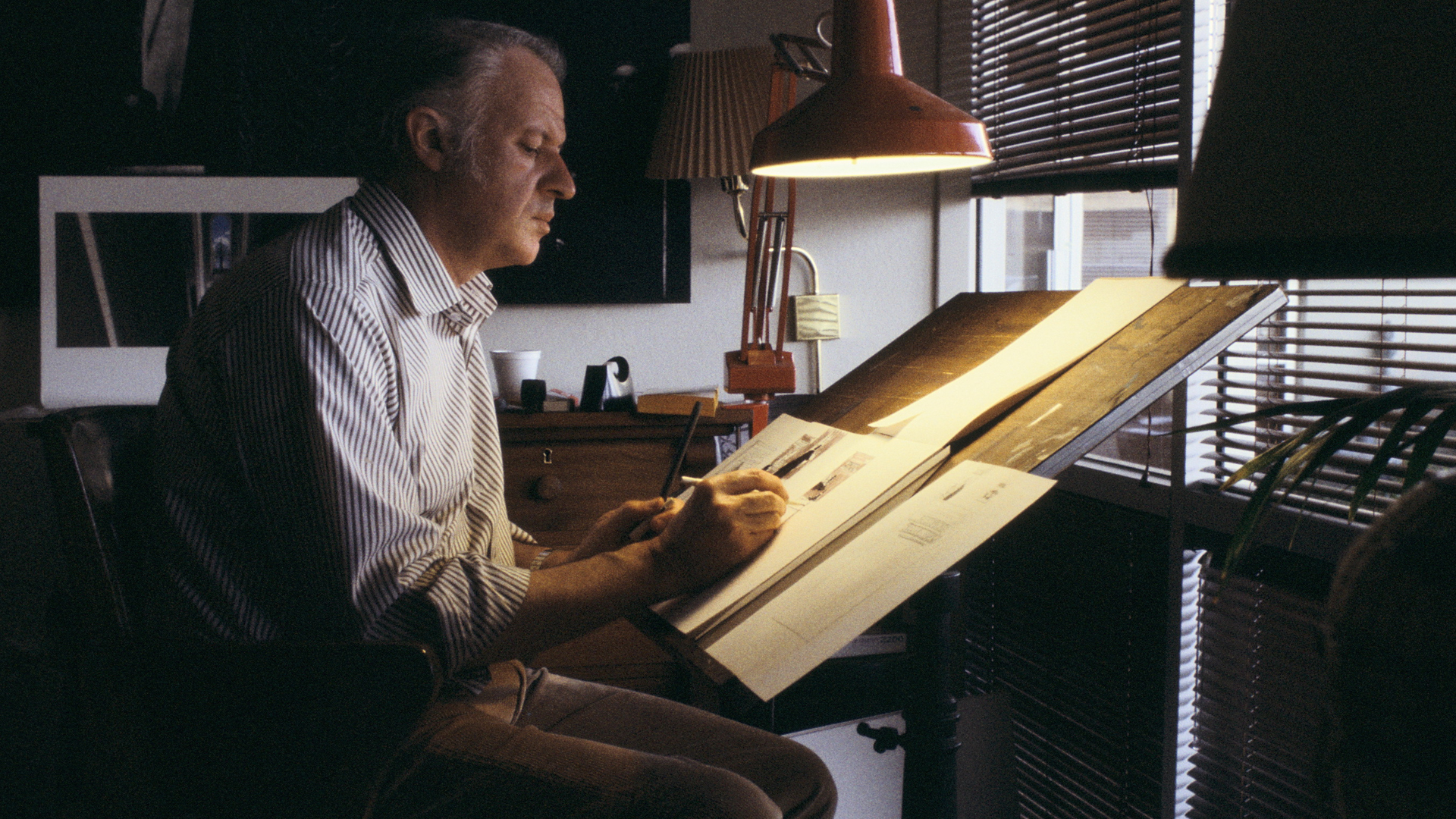 Concept Designer Ralph McQuarrie working at his drawing board on illustrations for the original trilogy. © and ™ Lucasfilm. All Rights Reserved